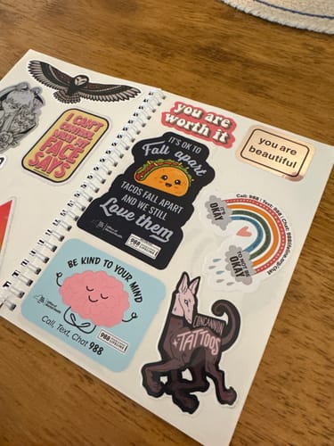 Reviewer's Unused Sticker Book, open to a page filled with a variety of colorful stickers.