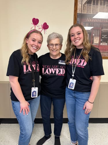 Customer and two other people wearing the black 'You Are So Loved' short sleeve shirt.