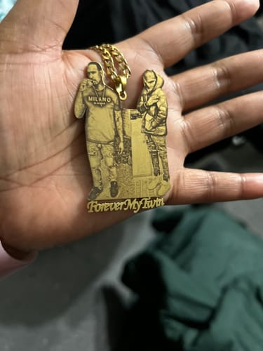 Customer holding a gold Custom Photo Engraved Pendant with an image of two people and the text 'Forever My Twin'.
