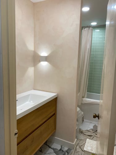 Customer's Sottile Floating Vanity in a light wood finish, installed in a bathroom nook.