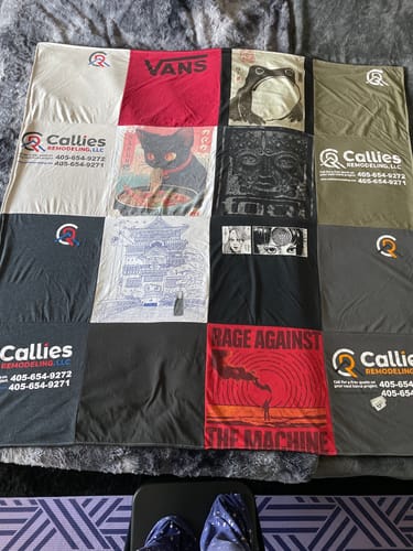 Customer's memorial Premium T Shirt Quilt made from various graphic t-shirts and laid out on a bed.