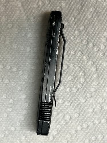 Another side view of the customer's VT Mini Stinger OTF Knife with worn black paint on the handle.