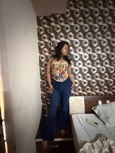 Reviewer posing for a photo in a bedroom.