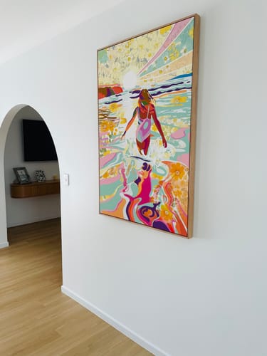 Customer's vibrant, framed Ocean Soul artwork hanging on a white wall in their home.