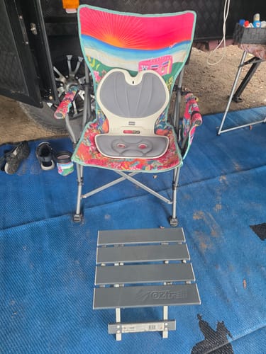 Customer's gray Mellow Posture Support placed on a colorful folding camping chair outdoors.