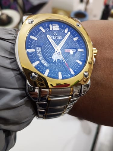 A customer's Bullston watch with a blue dial and a two-tone stainless steel strap on their wrist.