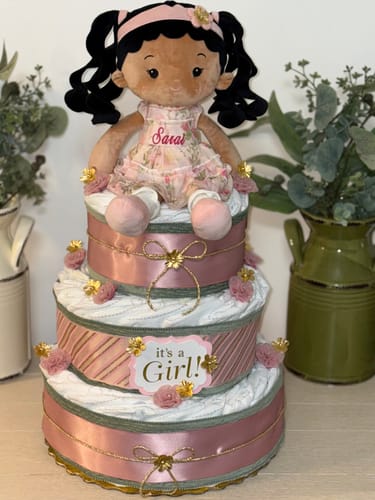 Customer's Personalized Princess Petal doll sitting on a decorated, three-tier diaper cake.