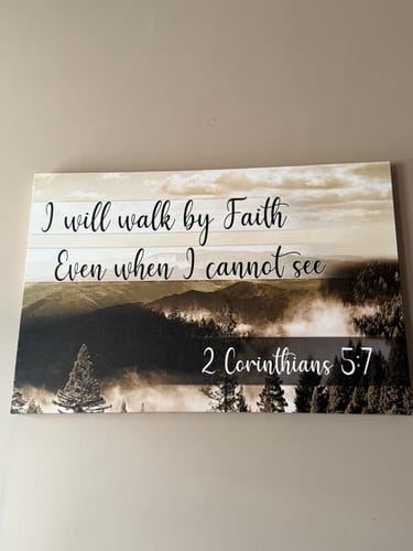 Customer's "I Will Walk By Faith" canvas print with a mountain scene, hanging on a neutral-colored wall.