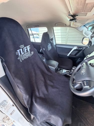 Customer's two black Waterproof Car Towel Seat Covers draped over the front driver and passenger seats of a car.