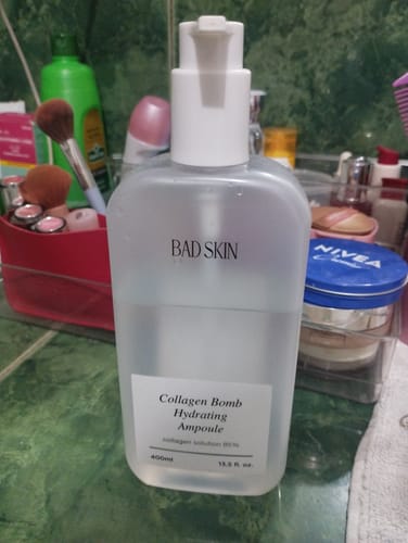 Reviewer's 400ml bottle of Bad Skin Collagen Bomb Hydrating Ampoule on a bathroom counter.