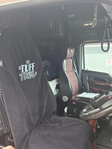 Customer's black Waterproof Car Towel Seat Cover protecting the driver's seat in a large truck cab.