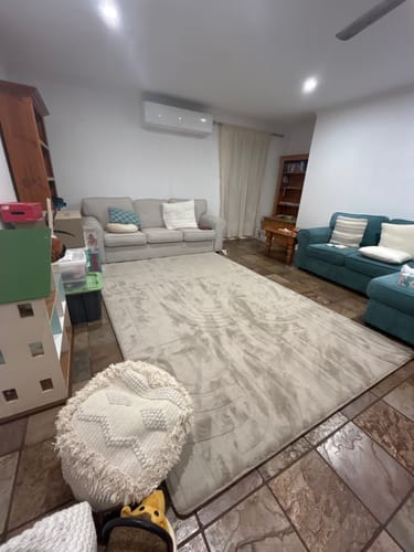 Customer's large, soft Mellow Mat laid out on the tiled floor of a living room.