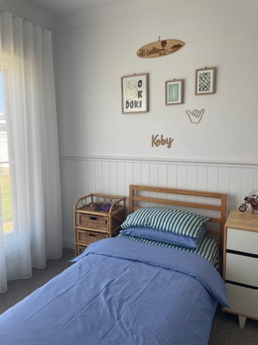 Customer's framed Surf Board Checkers Art Print hanging on a gallery wall in a child's bedroom.