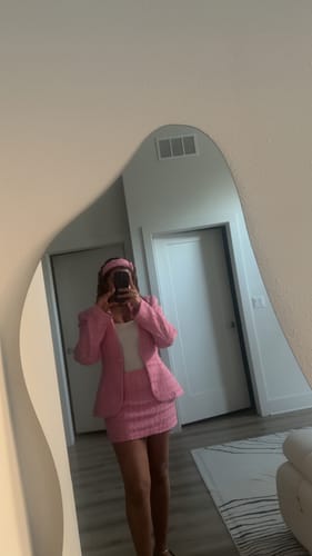 Reviewer in a mirror selfie wearing the pink Tweed Suiting Button Blazer with a matching skirt and headband.