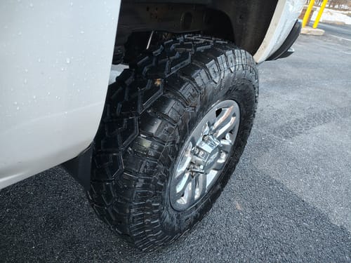 Close-up of a customer's truck tire and chrome wheel after installing the 2-inch wheel spacers.