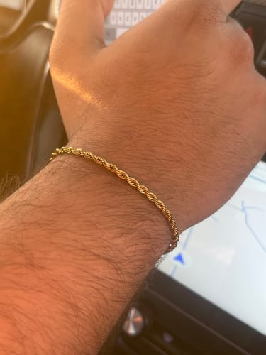 Primer plano de la Pulsera Rope Oro de 3mm en la muñeca de un cliente, mostrando su diseño trenzado.