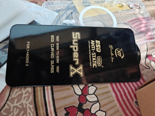 Customer's UltraShield Tempered Glass for a Nord 5 phone, shown with its black protective film before application.
