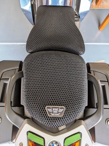 Customer's overhead view of the black mesh Wind Rider Seat Cover fitted on a two-part motorcycle seat.
