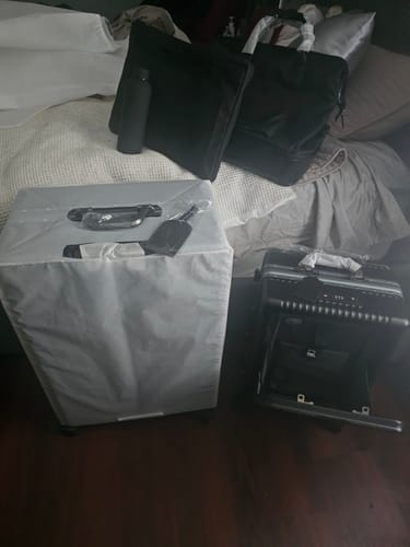 Reviewer's new black Check-In: All-In-One 28" suitcase with matching bags and accessories unboxed.