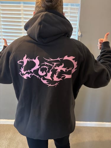 Reviewer from behind wearing the oversized black STRAY KIDS DO IT zip up hoodie, showing the pink graphic.