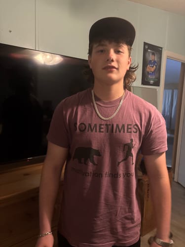 Customer wearing the purple Motivation T-shirt, showing its relaxed fit and bear graphic.