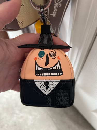 Reviewer holding the Mayor keychain from the Loungefly Nightmare Before Christmas mystery box set.