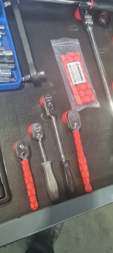 Customer's red Heat Shrink Handles installed on several ratchets inside a tool drawer.