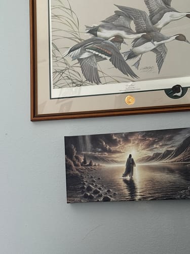 Customer's inspirational Walking on Water faith wall art hanging on a light blue wall.
