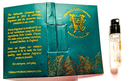 Customer's Honeyberry fragrance sample vial shown next to its teal and gold card packaging.