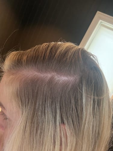 Close-up of a reviewer's blonde hair showing a soft root transition after using the Sunkissed Starter Kit.