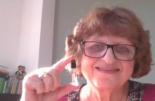 Reviewer happily holding up a small sample vial of Honeyberry.