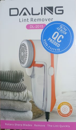 Customer's photo of the packaging for the Daling Lint Trimmer, a white and orange device, next to sweaters.