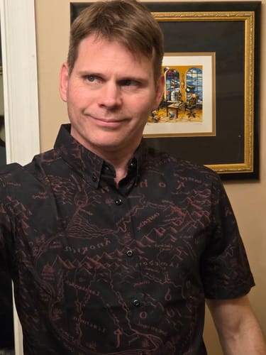 Reviewer wearing the black Lord of the Rings 'The World Is Changed' shirt, showing the red map design.