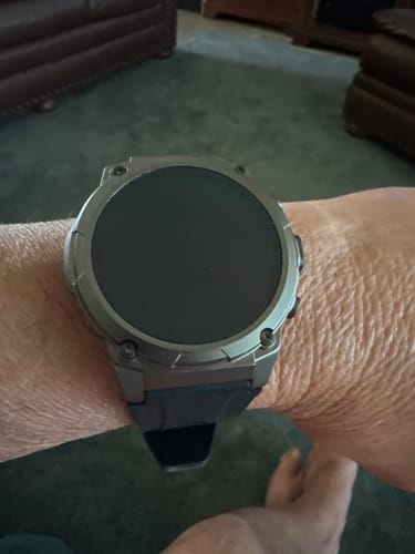 Customer wearing the Gard Pro Ultra 3 watch with a dark case on their wrist inside their home.