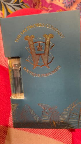 Customer's sample vial of Honeyberry perfume in its decorative blue card holder with gold lettering.
