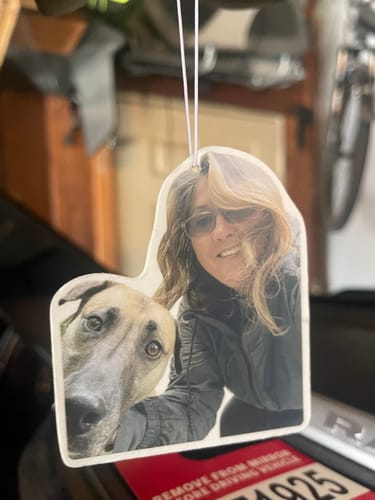Customer's custom air freshener with a selfie of a person and a dog hanging from a car mirror.