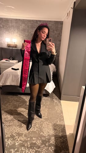Reviewer's mirror selfie showing the fit of the Suiting Blazer Mini Dress, styled with boots and a tiara.