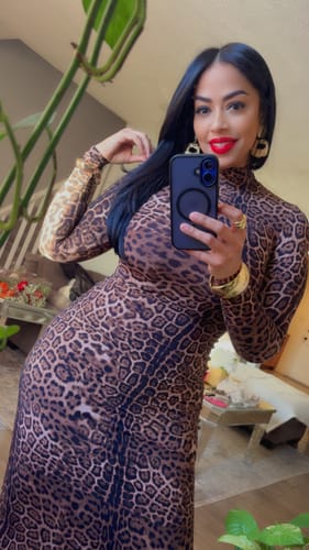 Reviewer taking a mirror selfie in the Naked Leopard Maxi Dress, showing the bodycon fit and long sleeves indoors.