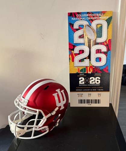 Customer's personalized National Championship metal ticket stub art displayed next to an Indiana football helmet.