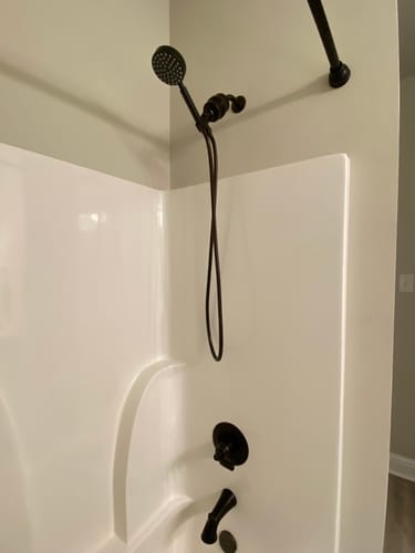 Customer's dark metal Handheld Shower Head Set with Filter installed in a white shower.