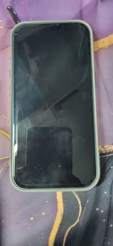 Customer's smartphone with the UltraShield Tempered Glass applied, showing a good fit on the dark screen.