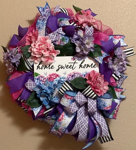 Reviewer's decorative wreath using the fabric hydrangea bush with colorful ribbons and a 'home sweet home' sign in the center.