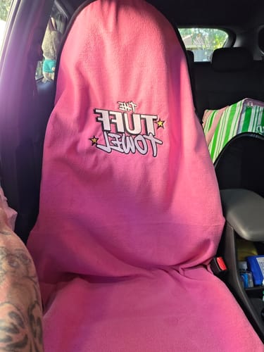 Customer's bright pink Waterproof Car Towel Seat Cover draped over a car passenger seat.