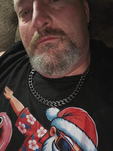 Customer wearing the aged Knights Templar Cuban Link Necklace against a graphic t-shirt.