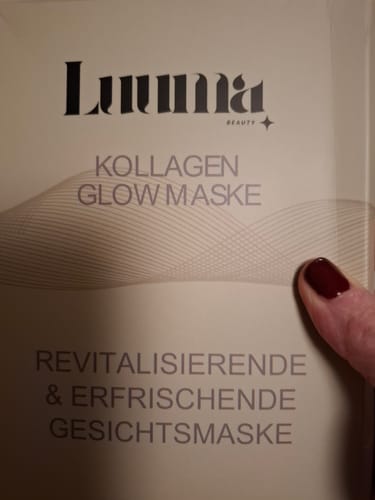 Die Hand eines Kunden zeigt auf die cremefarbene Verpackung der Kollagen Glow Maske.