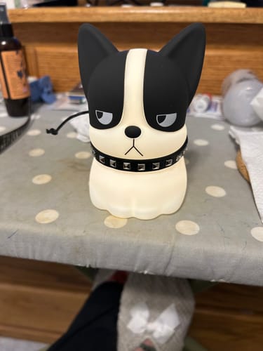 Customer's French bulldog night light with a studded collar, shown unlit on a table.
