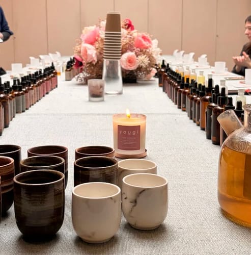 Customer photo from the Candle Making Workshop showing a cosy table set with essential oils and a lit candle.