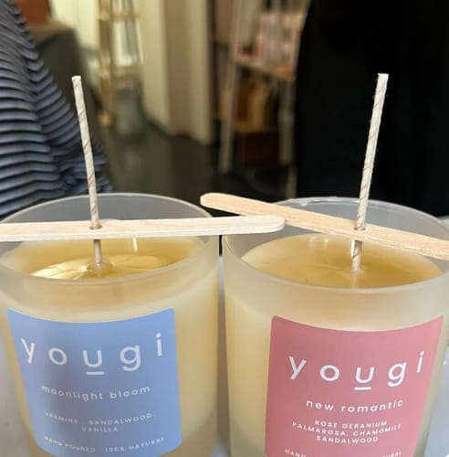 Customer's two finished Yougi candles in frosted glass jars from the candle making workshop, with wicks setting.