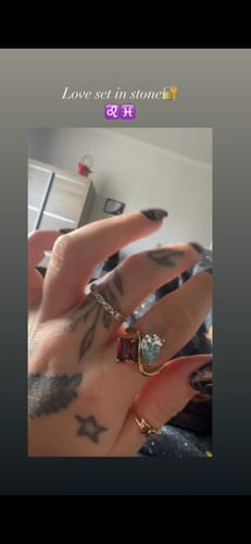 Close-up of a reviewer wearing the Navae Birthstone Ring on their tattooed hand.