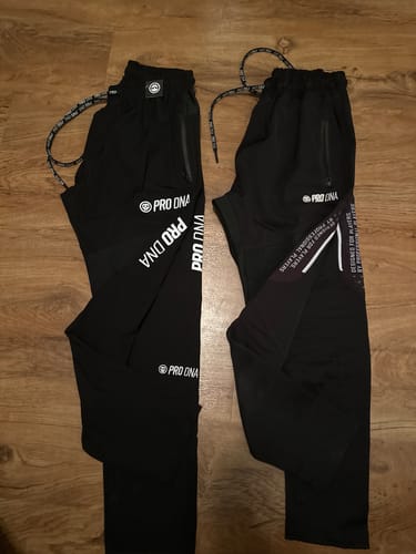 Customer's black PRO DNA Hyperlight Pro Core Pants (left) compared to another pair of pants on a wood floor.
